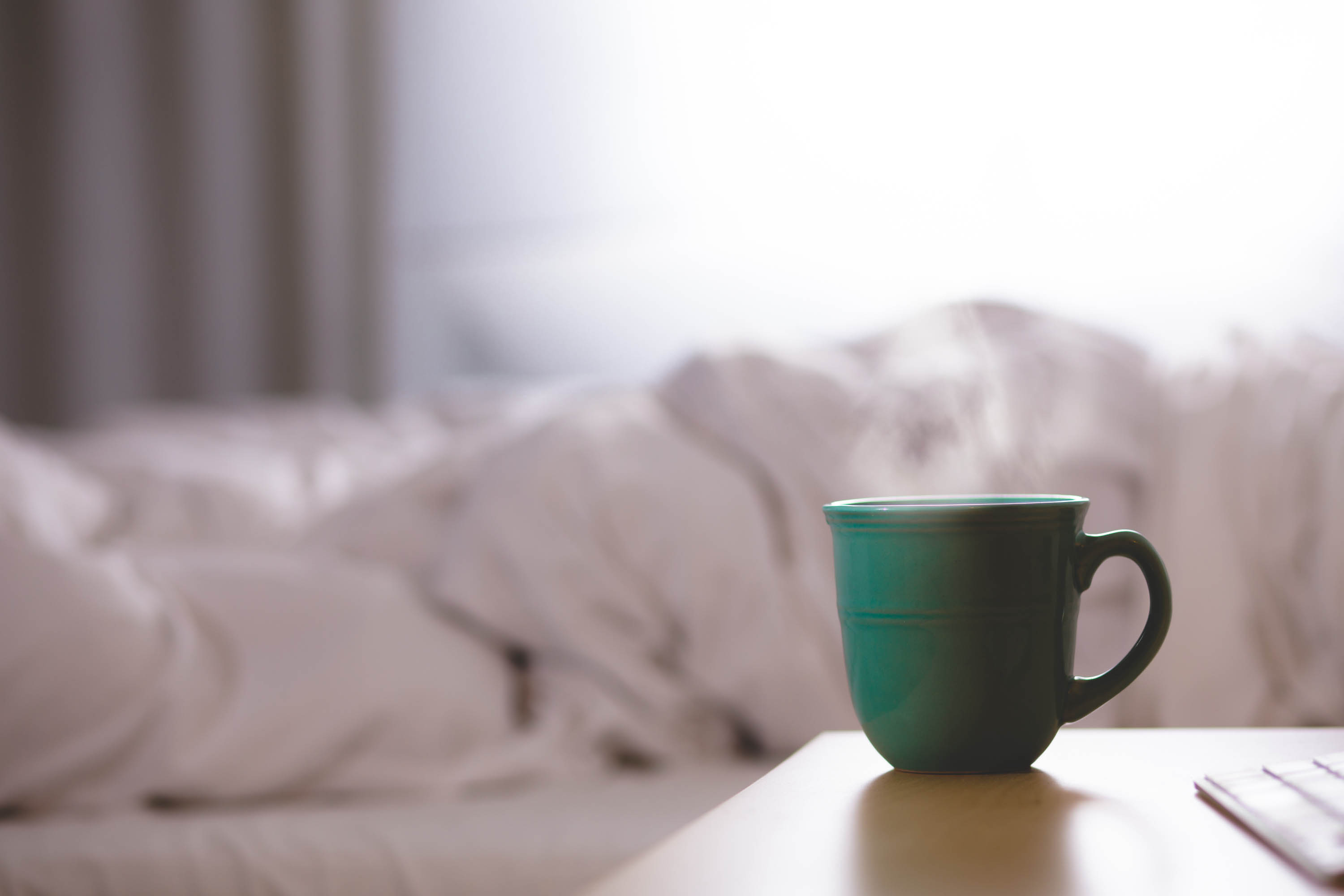A quiet bedroom with a cup of coffee